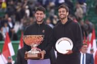 Carlos Alcaraz (left) and Lorenzo Musetti (right) posing with the men's singles winner's and runner-up's trophies respectively at the 2025 Monte-Carlo Masters (Source: Getty)